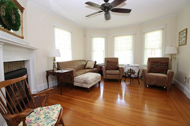 27 Summer St, Saugus, MA 01906 - sitting room with ornamental molding, ceiling fan, light wood-style floors, baseboards, and a fireplace