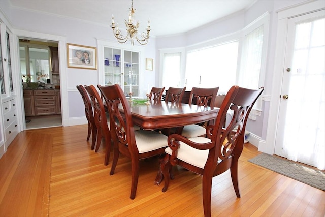 27 Summer St, Saugus, MA 01906 - dining area with a chandelier, healthy amount of natural light, light wood-style flooring, and ornamental molding