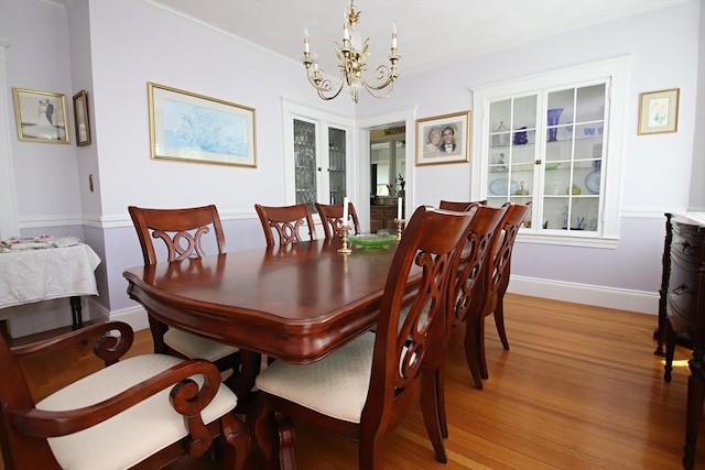 27 Summer St, Saugus, MA 01906 - dining space with a chandelier, light wood finished floors, and baseboards