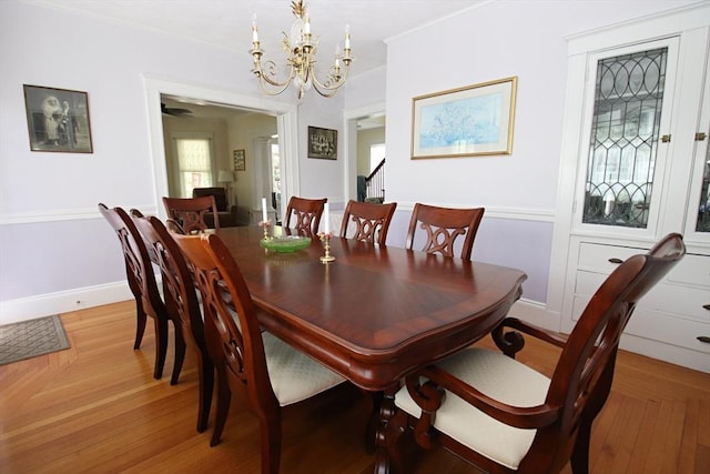 27 Summer St, Saugus, MA 01906 - dining area with a chandelier, baseboards, light wood finished floors, and stairs