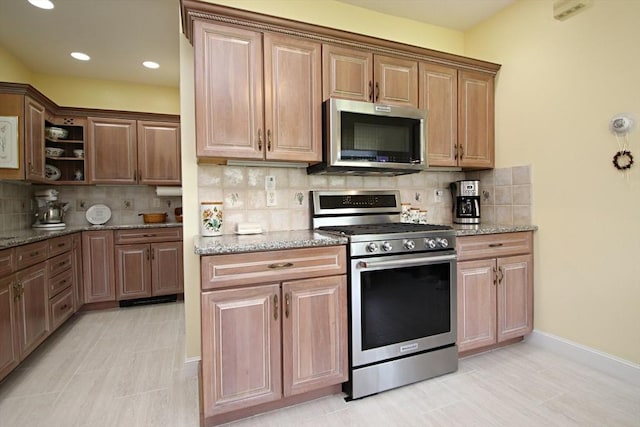 27 Summer St, Saugus, MA 01906 - kitchen with appliances with stainless steel finishes, tasteful backsplash, light stone countertops, baseboards, and recessed lighting