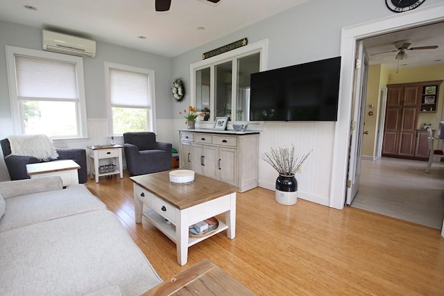 27 Summer St, Saugus, MA 01906 - living area with a ceiling fan, a wall mounted AC, light wood-type flooring, and a wainscoted wall