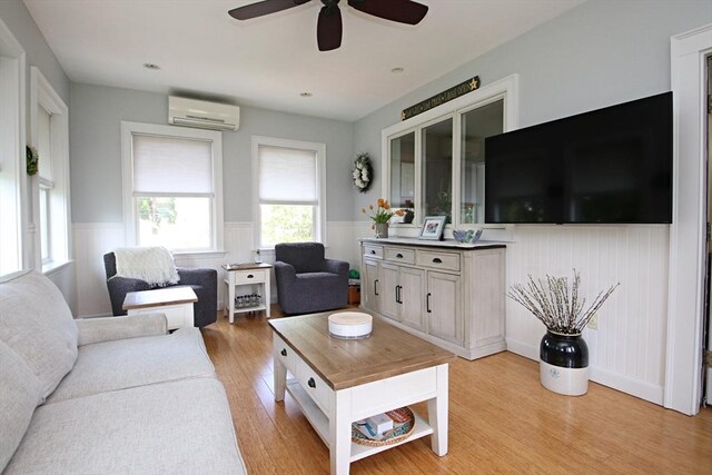 27 Summer St, Saugus, MA 01906 - living room featuring a wall mounted AC, wainscoting, ceiling fan, and light wood finished floors