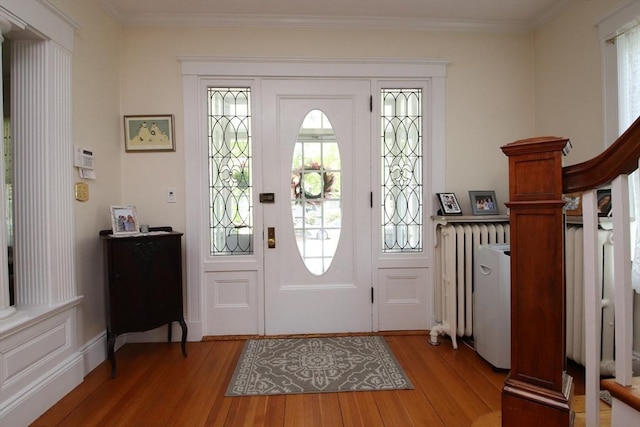 27 Summer St, Saugus, MA 01906 - foyer entrance featuring wood finished floors, crown molding, radiator, and plenty of natural light