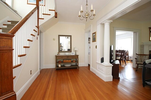 27 Summer St, Saugus, MA 01906 - foyer featuring ornate columns, stairway, wood finished floors, crown molding, and a chandelier