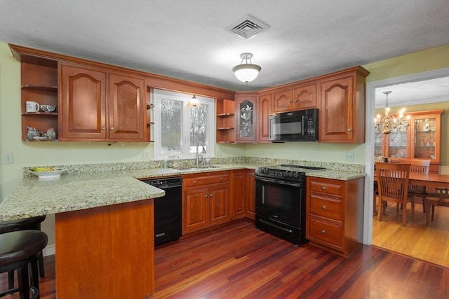 kitchen with visible vents, dark wood-style floors, black appliances, open shelves, and a sink