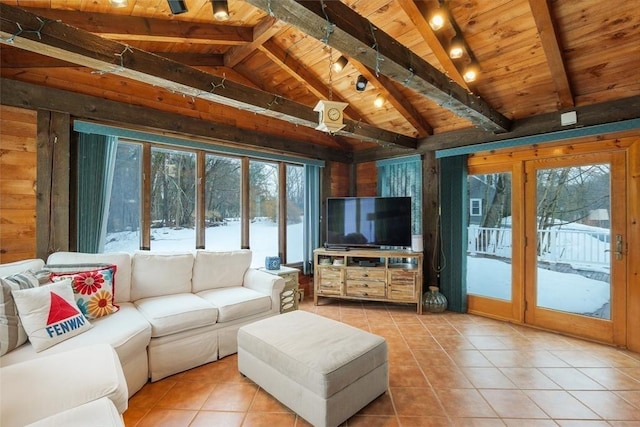 living area featuring wooden walls, wooden ceiling, a healthy amount of sunlight, and lofted ceiling with beams