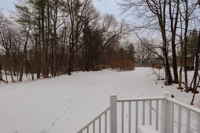 yard layered in snow featuring a balcony