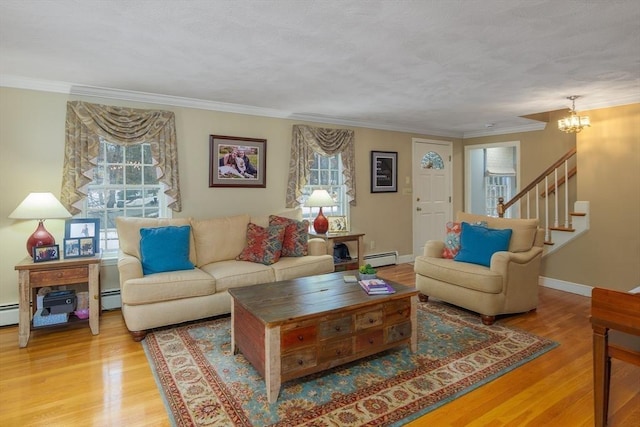 living room with stairway, a wealth of natural light, and wood finished floors