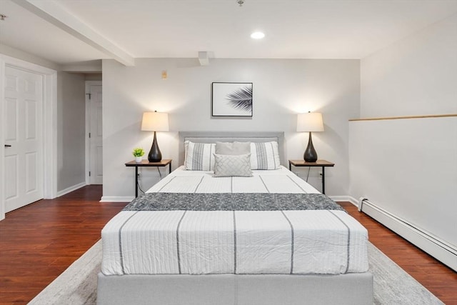 bedroom with dark hardwood / wood-style flooring, beam ceiling, and baseboard heating