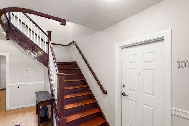 stairs with hardwood / wood-style floors