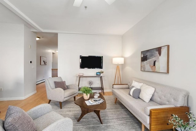 living room featuring hardwood / wood-style flooring and a baseboard heating unit