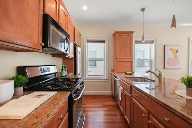 297 Cardinal Medeiros Ave Unit 1, Cambridge, MA 02141 - kitchen featuring appliances with stainless steel finishes, a sink, baseboards, dark wood finished floors, and light stone counters