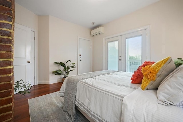 297 Cardinal Medeiros Ave Unit 1, Cambridge, MA 02141 - bedroom featuring an AC wall unit, french doors, access to exterior, wood finished floors, and baseboards