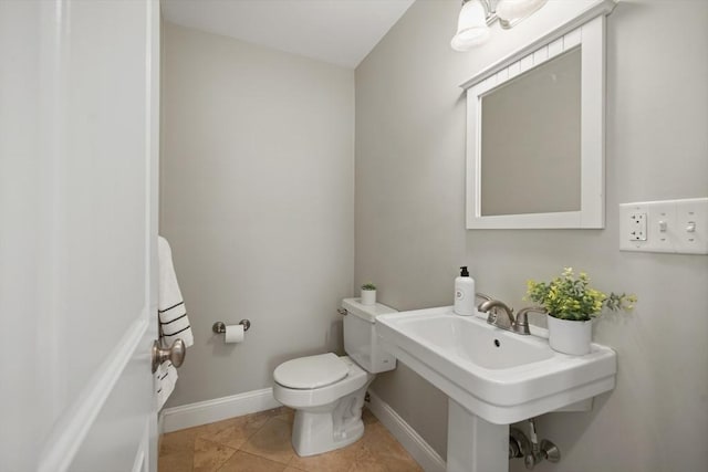 297 Cardinal Medeiros Ave Unit 1, Cambridge, MA 02141 - half bath with toilet, baseboards, tile patterned floors, and a sink
