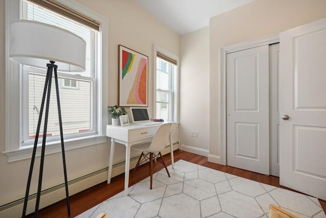 297 Cardinal Medeiros Ave Unit 1, Cambridge, MA 02141 - office featuring baseboard heating, wood finished floors, and baseboards