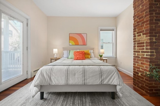 297 Cardinal Medeiros Ave Unit 1, Cambridge, MA 02141 - bedroom featuring dark wood finished floors and baseboard heating