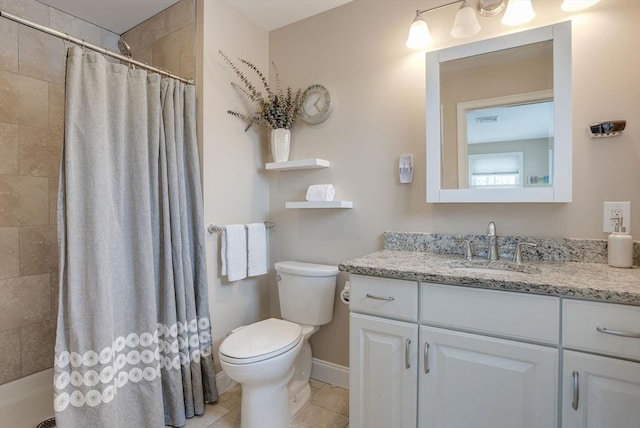 bathroom with a shower with curtain, vanity, toilet, and tile patterned floors