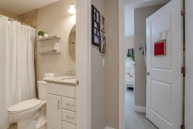 bathroom with vanity, a shower with shower curtain, and toilet