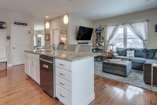 kitchen featuring white cabinetry, dishwasher, sink, pendant lighting, and a center island with sink