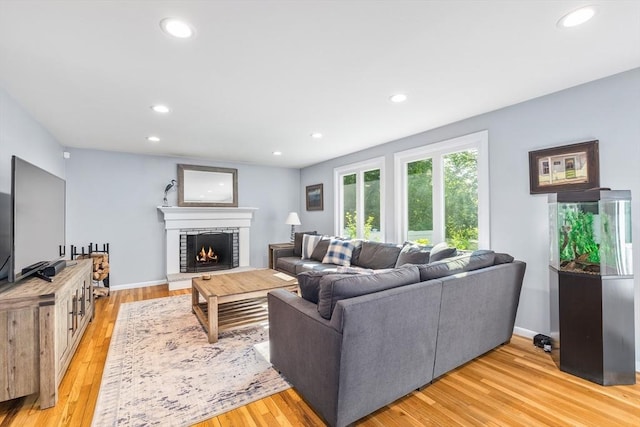 61 Northbridge Rd, Mendon, MA 01756 - living room featuring recessed lighting, a brick fireplace, light wood-style flooring, and baseboards