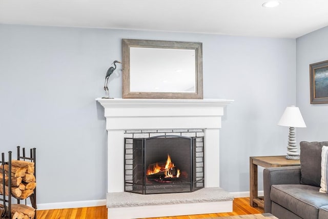 61 Northbridge Rd, Mendon, MA 01756 - living area with a lit fireplace, wood finished floors, recessed lighting, and baseboards