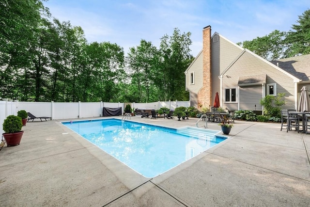 61 Northbridge Rd, Mendon, MA 01756 - view of swimming pool featuring a patio, a fenced backyard, outdoor dining space, and view of wooded area