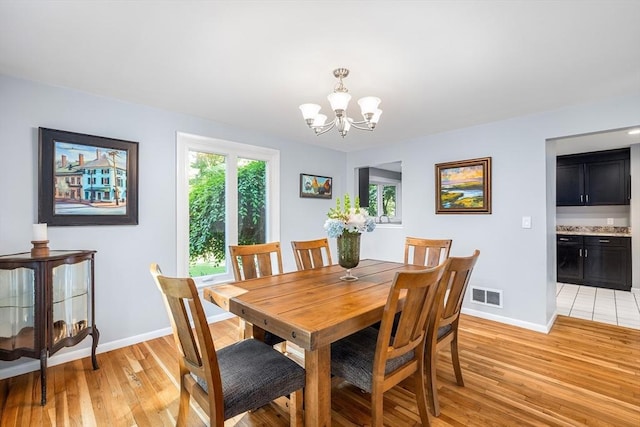 61 Northbridge Rd, Mendon, MA 01756 - dining room featuring a chandelier, baseboards, and light wood-style flooring