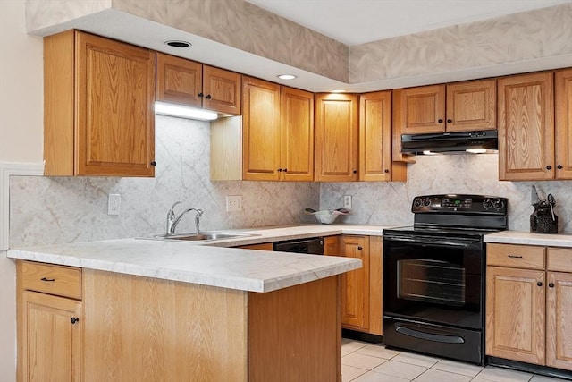 5 Thomas St Unit P17, Saugus, MA 01906 - kitchen with black range with electric stovetop, under cabinet range hood, light countertops, a peninsula, and decorative backsplash