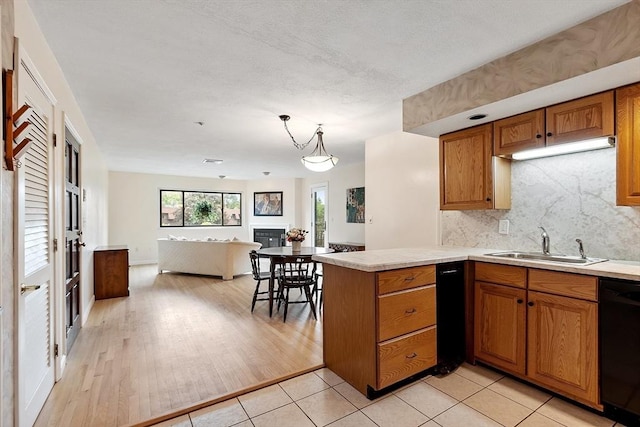 5 Thomas St Unit P17, Saugus, MA 01906 - kitchen featuring black dishwasher, brown cabinets, open floor plan, light countertops, and a peninsula