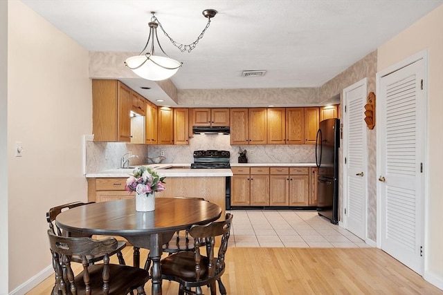 5 Thomas St Unit P17, Saugus, MA 01906 - kitchen featuring black appliances, under cabinet range hood, light countertops, and tasteful backsplash