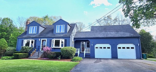 cape cod home with an attached garage, a chimney, driveway, and a front lawn