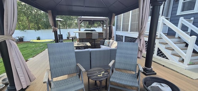 view of patio / terrace with fence, a wooden deck, a gazebo, and outdoor lounge area