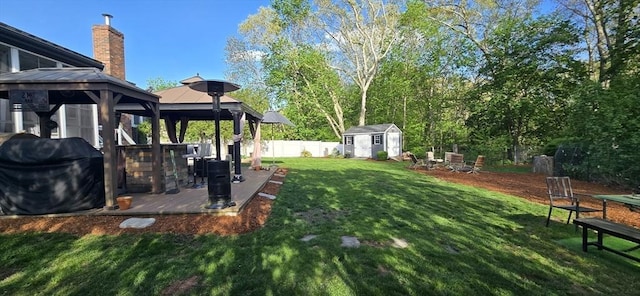 view of yard with a gazebo, a shed, an outbuilding, and a patio