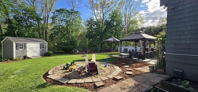 view of grassy yard featuring a gazebo, a patio area, an outbuilding, and a shed