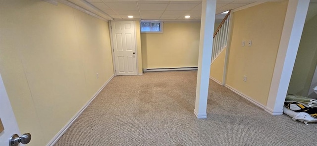 basement with carpet floors, a baseboard heating unit, recessed lighting, and stairway