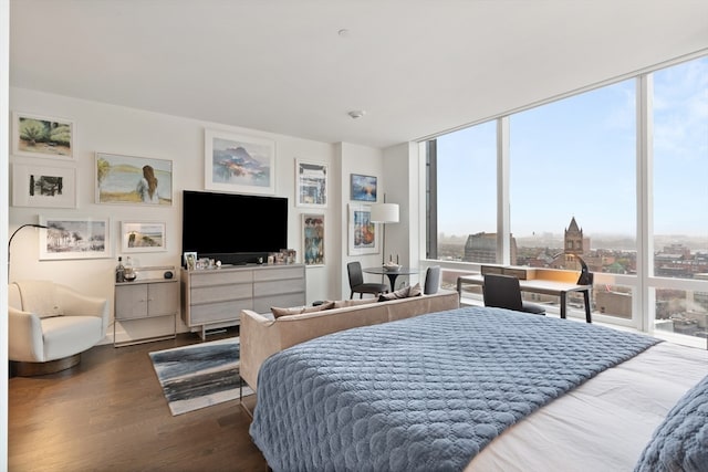 bedroom featuring hardwood / wood-style flooring and a wall of windows