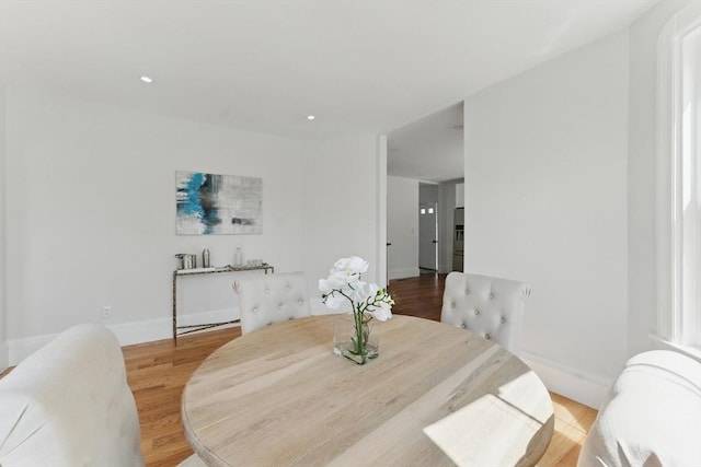 dining space featuring wood finished floors, baseboards, and recessed lighting