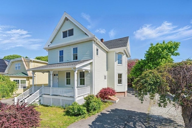 view of front of property featuring a porch and a chimney