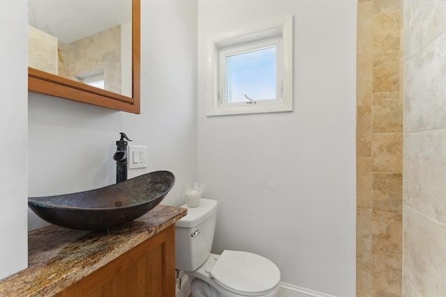 bathroom featuring toilet and vanity