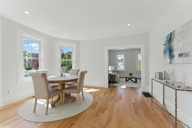 dining area with light wood-type flooring, baseboards, and recessed lighting