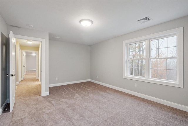 unfurnished bedroom with light colored carpet and baseboards