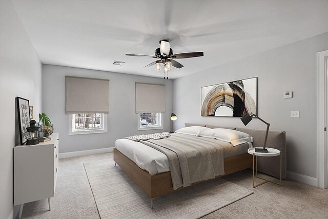 bedroom featuring baseboards, light carpet, and ceiling fan