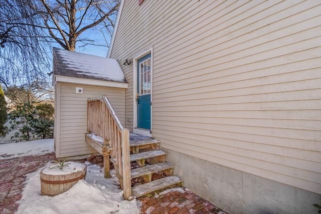 view of snow covered property entrance