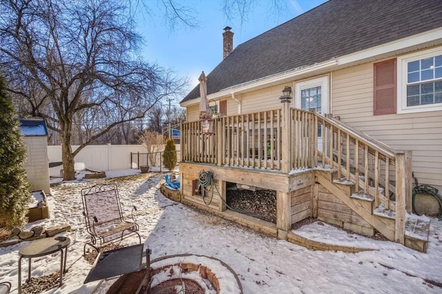 exterior space featuring a wooden deck and an outdoor fire pit