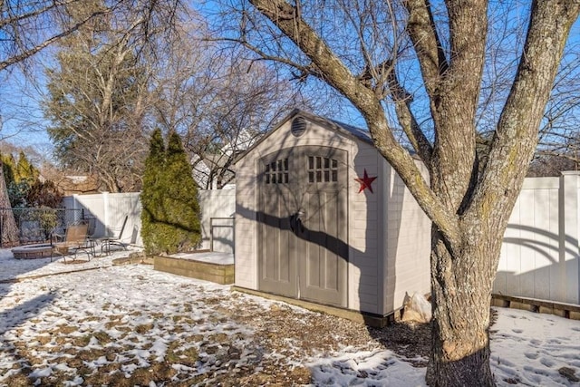 snow covered structure featuring an outdoor fire pit