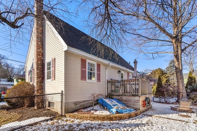 view of snow covered exterior featuring a wooden deck