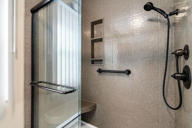 bathroom with a tile shower