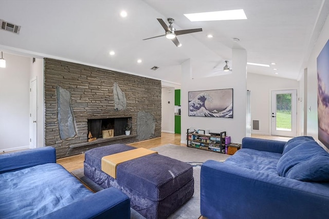 128 Clinton St, Hopkinton, MA 01748 - living area featuring a ceiling fan, a stone fireplace, a skylight, lofted ceiling, and wood finished floors