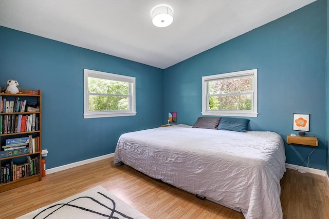 128 Clinton St, Hopkinton, MA 01748 - bedroom with vaulted ceiling, wood finished floors, and baseboards